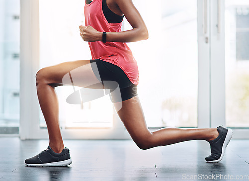 Image of Lunges, fitness and legs of a woman in the gym for wellness, training and health commitment. Strong, cardio and a female athlete stretching for a workout, exercise and sports for body muscle