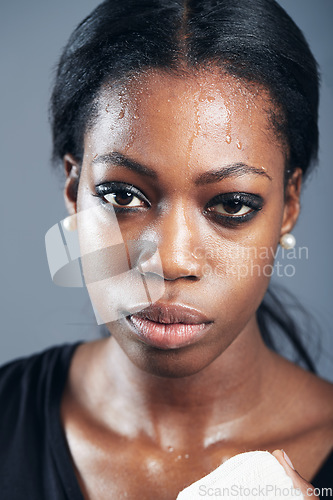 Image of Portrait, boxing and a woman sweating in studio on a gray background for self defense, fitness or training. Face, exercise and workout with a black female boxer practising for a fighting competition