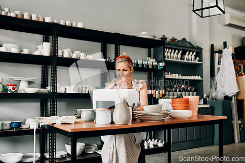 Image of Creative, pottery and woman sitting with laptop in workshop. Small business or startup, technology or social networking and female person in kitchen with art sculpture on the table or on desk