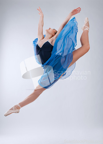 Image of Woman, ballet dancing and studio with jump in air, art movement and beauty for training. Professional dancer, dance performance and finesse in class with strong body, wellness and freedom at concert