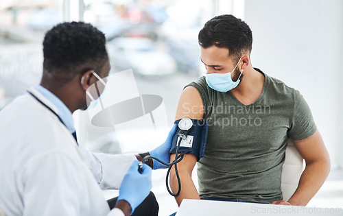 Image of Covid, mask and doctor exam hypertension of a patient in a hospital or cardiology test by medical worker in a clinic. Health, man and professional healthcare employee consulting for blood pressure
