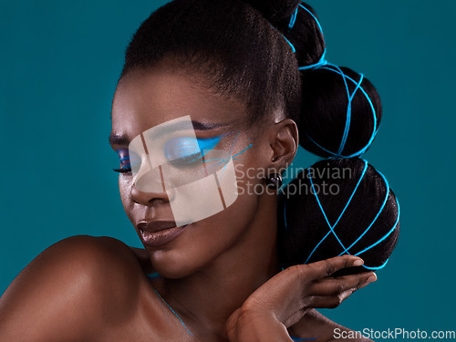 Image of Face, hand and hair with a model black woman in studio on a blue background for hair or cosmetics. Eyes closed, makeup and fashion with an attractive young female person posing to promote beauty