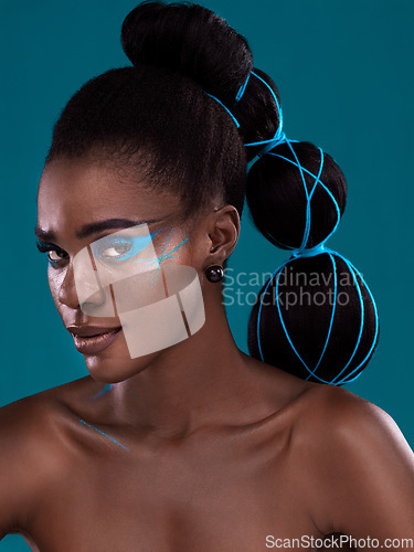 Image of Portrait, hair and makeup with an african woman model in studio on a blue background for haircare or fashion. Face, cosmetics and style with an attractive young female person posing for haircare