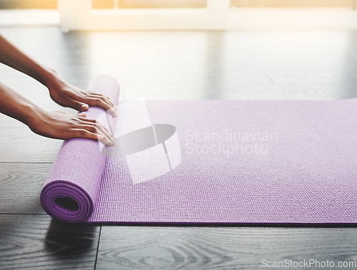 Image of Hands, closeup and yoga mat roll on floor for exercise, meditation or spiritual training in home, gym or room. Black woman, workout mockup or prepare for pilates and balance, fitness and wellness