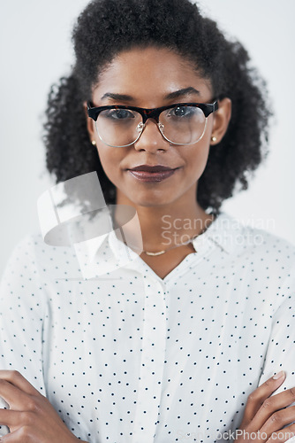 Image of Serious, business and portrait of black woman with arms crossed in studio isolated on white background. Glasses, confidence or face of African female professional, entrepreneur or person from Nigeria