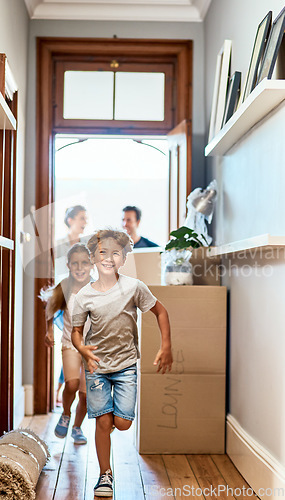 Image of Home, boy and girl running in a hallway, real estate and family with boxes, move and happiness. Parents, siblings and female kid with male child, smile and excited for new apartment, run and property