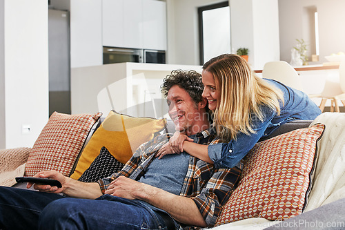 Image of Happy couple, hug and watching tv in home for movie, film show and news broadcast in living room. Mature man, woman and smile on sofa for television series, video subscription and streaming platform