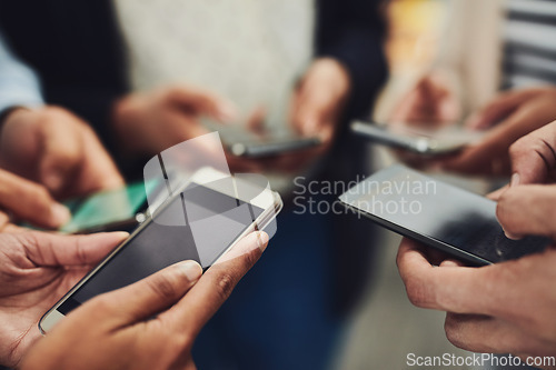 Image of Business people, phone and hands for networking, connection or communication together at office. Hand of group holding mobile smartphone in social media, data sync or sharing information at workplace