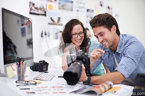 Image of Happy photographers, smile and camera at office for photo, memory or teamwork at the studio. Man and woman in team photography smiling for digital advertising, marketing or photos at the workplace