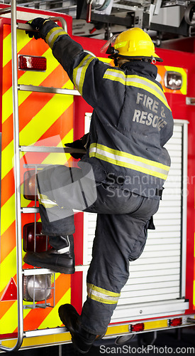 Image of Firefighter, man and climbing ladder for emergency operation, service or rescue with equipment. Fireman person with helmet, jacket and gear protection getting on truck for firefighting at station