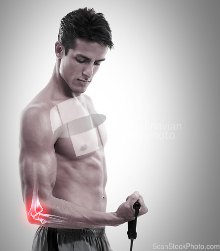 Image of Man, elbow and x ray in weightlifting injury, workout or exercise against a gray studio background. Muscular male lifting weight with sore arm, ache or pain from sports accident on mockup space