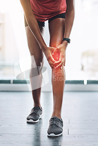 Image of Hands, pain and knee injury with a woman in studio holding an injury to her joint while training for fitness. Accident, emergency and anatomy with a female athlete suffering from muscle inflammation