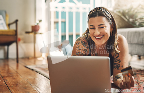 Image of Laptop, credit card and woman on floor in online shopping, e commerce and fintech, home payment or finance. Happy person relax on carpet, banking or website sale, discount or subscription on computer