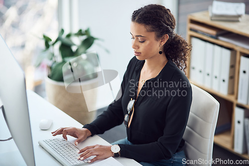 Image of Professional, typing and a woman with an email on a computer, research or secretary work. Analytics, desk and a African female receptionist with a pc in an office for connectivity and working