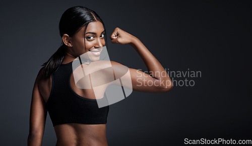 Image of Portrait, smile and woman flexing back in studio isolated on a black background mockup. Strong flex, happy and Indian female athlete with bicep, arm strength or bodybuilder muscle, fitness or workout