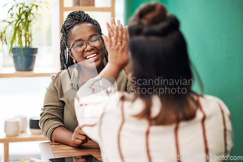 Image of Happy, friends and women in a cafe, high five and bonding with agreement, happiness and joyful. Female people, girls and students with support, coffee shop and excited with a smile, goal and target