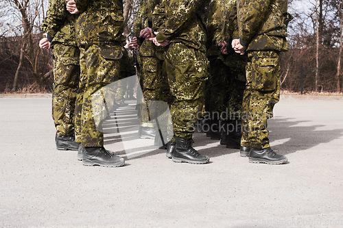 Image of Army, military and group of soldiers training together outdoor for war, service or mission. Feet of men or team in formation for exercise, safety and security in camouflage uniform as defence