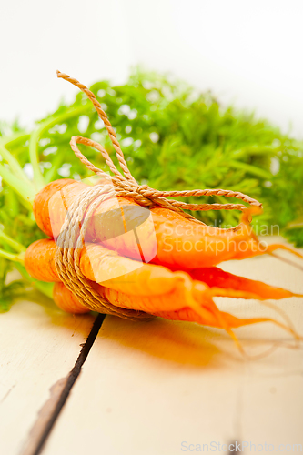 Image of baby carrots bunch tied with rope