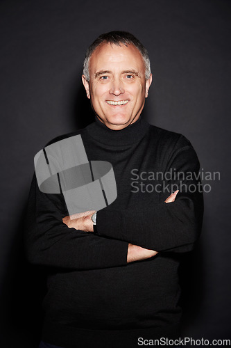 Image of Portrait, smile and senior man with arms crossed, confident and wellness against a dark studio background. Face, happy male person and mature model with happiness, retirement and carefree with joy