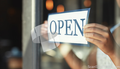 Image of Open sign, restaurant window and hands of person, small business owner or manager with cafe door poster for welcome. Retail sales waitress, coffee shop barista and closeup board for store service