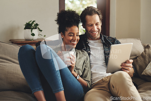 Image of Relax, home and interracial couple on a couch, tablet and happiness with social media and connection. Partners, man and woman on a sofa, technology and loving with a smile, romance and online reading