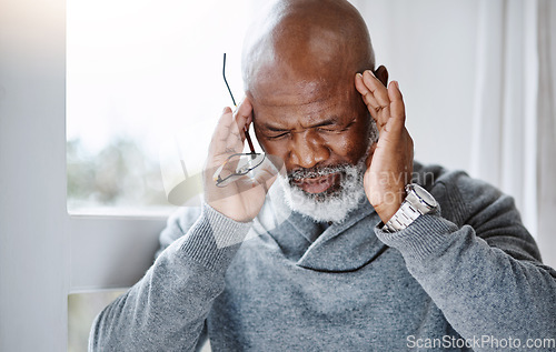 Image of Headache, pain and senior man with migraine, mental health risk, retirement stress or mind problem at home. Memory, tired and sick or african person massage temple by window, brain fog and healthcare