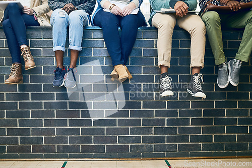 Image of Closeup, legs and students with education, wall and knowledge on a break, relax and university. Zoom, group and young people with sneakers, shoes and campus with fashion, scholarship and opportunity
