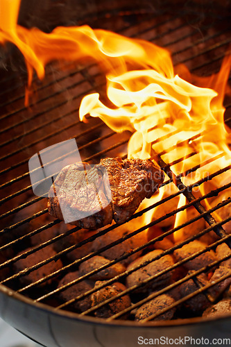 Image of Barbecue, food and steak on a fire for dinner, eating meat and cookout on the grill. Protein, flame and food grilling for a bbq and preparing beef for supper for hunger or health outdoors at home