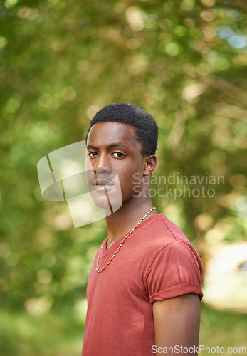 Image of Portrait, teen boy and outside in garden with bokeh blurred background or African teenager, nature and outdoor, park or summer. Young person, serious face and green, trees or spring sunshine