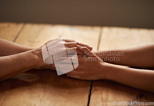 Image of Support, unity and closeup of people holding hands for grief, hope and sympathy after loss. Gratitude, empathy and friends in an intimate moment with affection for love, trust and solidarity on table