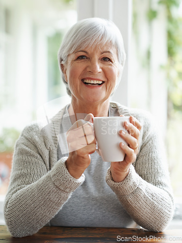 Image of Portrait, happy old woman and drinking coffee in home for break, relaxing morning and retirement. Face, laughing and senior lady enjoy cup of tea, warm beverage and hot drink in house with happiness