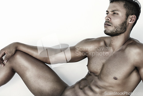 Image of Thinking, sexy and naked man isolated on a white background for fitness, healthy body and wellness. Young, relax and male model or nude person on floor in studio with abs and strong muscles or power