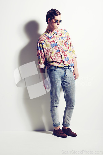 Image of Fashion, unique and funky with a hipster man in studio on a white background for contemporary style. Trendy, cool and edgy with a handsome young male model posing in stylish or fashionable clothes