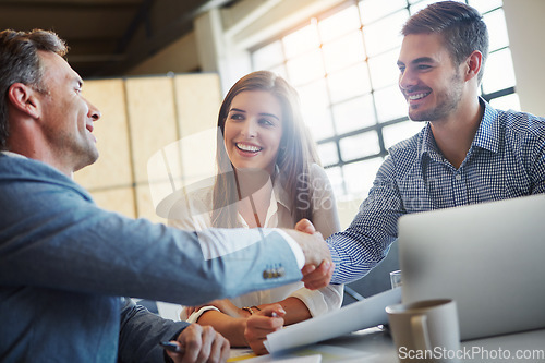 Image of Handshake, meeting and collaboration with business people in the office, in agreement of a deal or negotiation. Teamwork, thank you and professional men shaking hands in a corporate boardroom