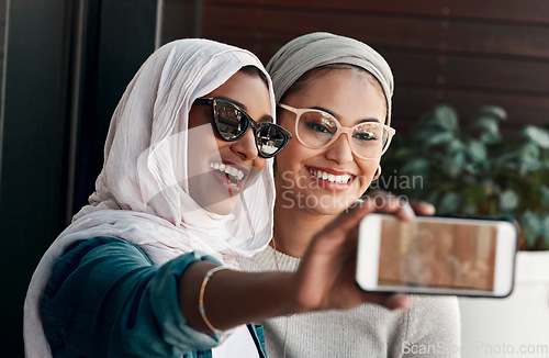 Image of Selfie, muslim people and friends with sunglasses in city for social media, influencer content creation or fashion blog. Happy gen z women in Saudi Arabia, emoji profile picture or online photography