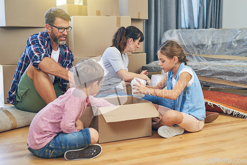 Image of Family, kids and moving with boxes for apartment as an investment for lifestyle together in a house. Children, box and parents in living room of a new home are packing for the mortgage for saving.