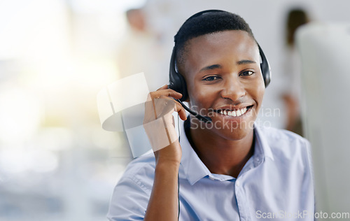Image of Virtual assistant, portrait or friendly black man in call center consulting or talking at customer services. Communication, happy smile or face of sales agent on mic in telemarketing or telecom desk