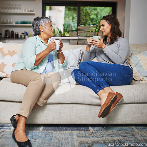 Image of Relax, coffee and mother with daughter on sofa in living room for bonding, conversation and happiness. Smile, chat and discussion with women talking in family home for generations, reunion and break