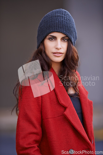 Image of Portrait, fashion and woman with winter clothes, outdoor and confident girl in the city. Face, female person or model with a red winter coat, beanie or stylish outfit with lady in the road or street