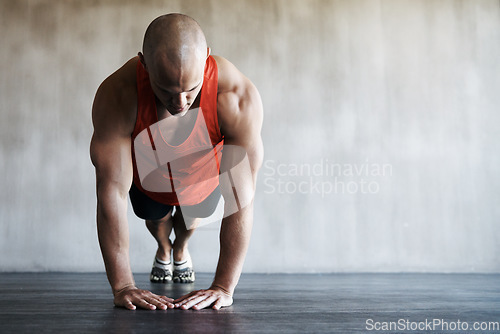 Image of Workout, gym and man in floor push up for exercise, health commitment or training for muscle growth. Fitness club mockup, healthy and body of strong person focus in athlete health challenge or pushup