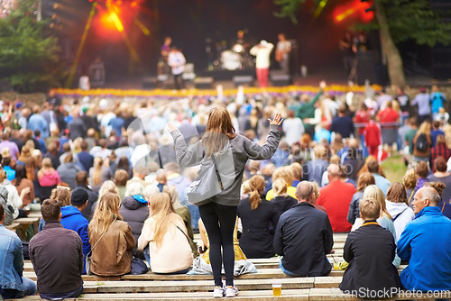 Image of Back, woman and group at a music festival, cheering and happiness on a weekend break. Female person, people and happy crowd at a party, dancing and joy with fun, excited and celebration for concert