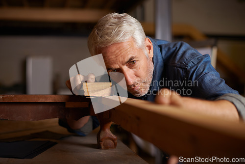 Image of Senior carpenter, wood sanding and man with precision on building construction and architecture project. Home improvement, handyman and work of a mature male employee with carpentry tool for woodwork