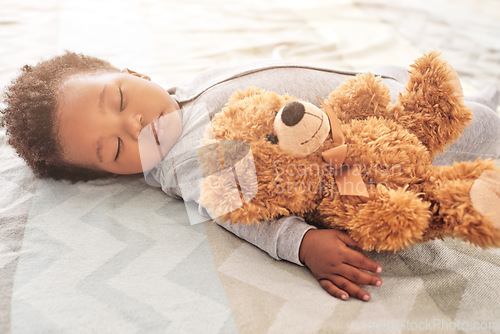 Image of Sleeping, teddy bear and newborn with baby in bedroom for comfort, development and innocence. Dreaming, relax and comfortable with tired African infant and toy at home for morning, rest and bedtime