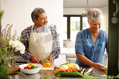 Image of Food, elderly couple and cooking while happy in kitchen of their home. Teamwork or help, vegetables and senior married people preparing a meal for dinner or lunch together in their house.