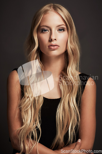 Image of Sexy, portrait and woman with beauty, confident and glamour against a dark studio background. Face, female person and model with wellness, black dress and elegant outfit with fashion and luxury