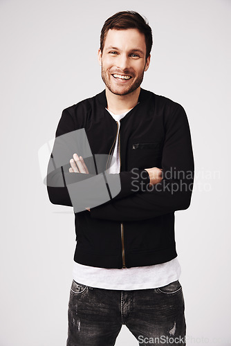 Image of Portrait, happy man and arms crossed in white background, casual style and confident attitude. Handsome young male model, laughing guy and smile in studio for good mood, happiness and fashion clothes