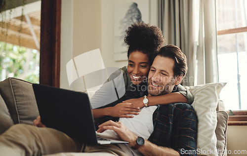 Image of Laptop, streaming and an interracial couple watching a movie using an online subscription service for entertainment. Computer, relax or internet with a man and woman bonding together over a video