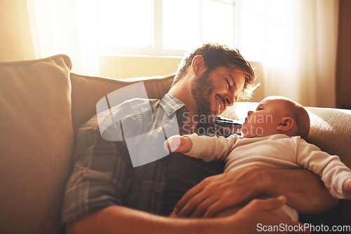 Image of Father, baby and love on a family home sofa with love, care and support for a child. Happy man or dad with a smile and kid for bonding, development and growth or happiness in relationship with parent