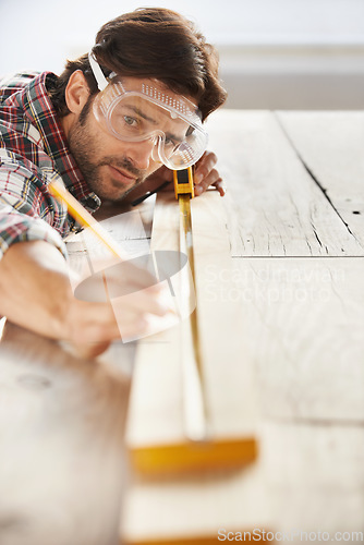 Image of Wood, carpenter man building project and measurement with tape at construction site. Home renovation or furniture design, handyman working on maintenance at workshop and woodwork or handcraft