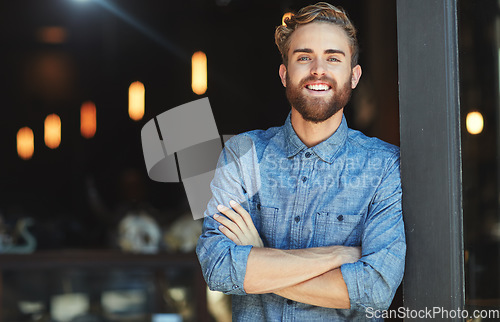 Image of Portrait, happy and man in a cafe, arms crossed and startup success with employment, business owner or joyful. Face, male employee or confident entrepreneur with a smile, coffee shop and professional